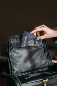 person putting a passport on bag