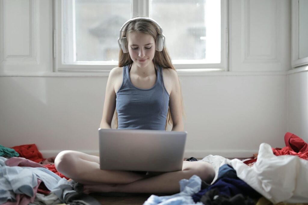 woman in blue tank top using macbook