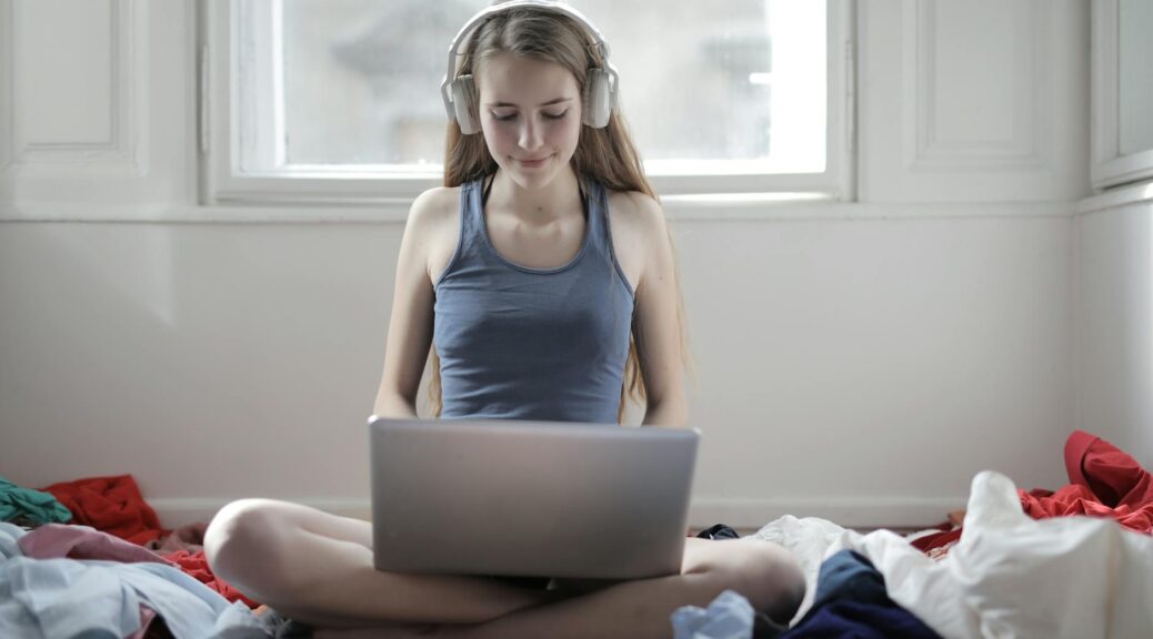 woman in blue tank top using macbook